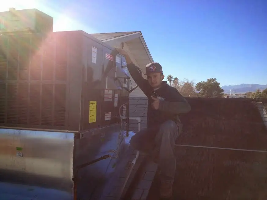 HVAC technician performing Boiler Repair on a rooftop unit in Antelope